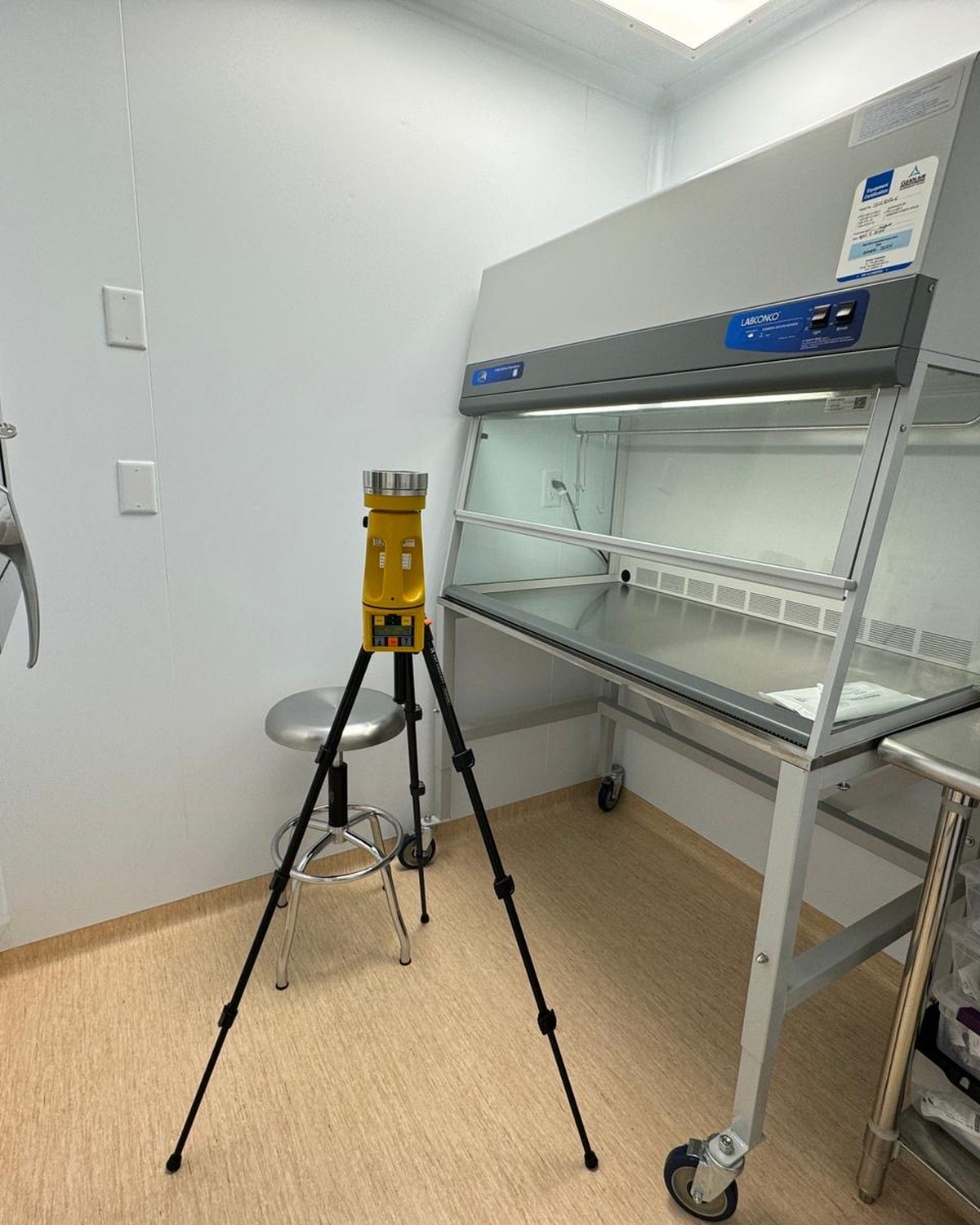 Viable air sampling on a tripod beside a laminar flow workstation in a non-sterile compounding room